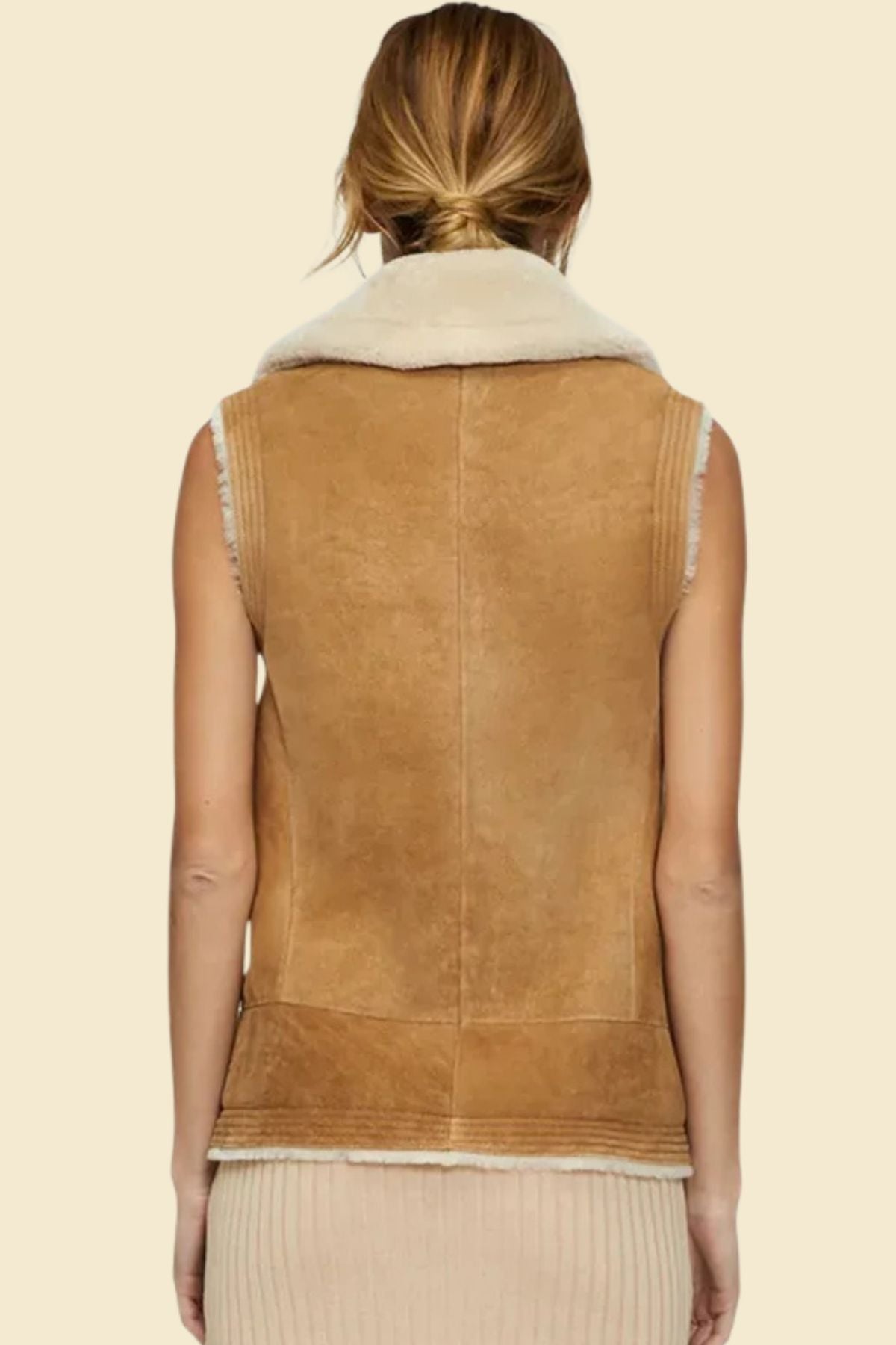 Close-up of vintage leather and sherpa texture on women’s aviator vest.