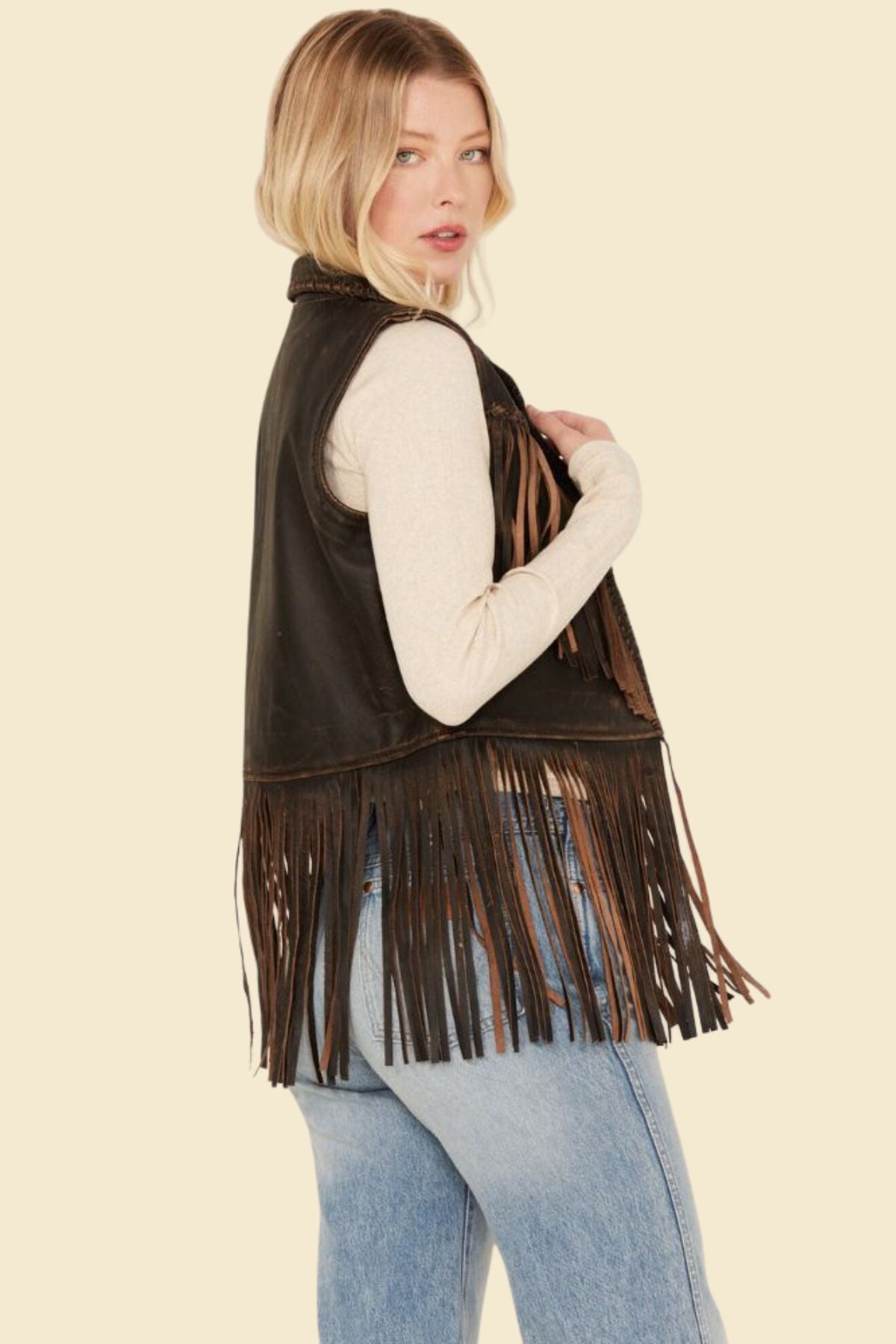 Stylish women's leather vest with stitched fringe and tailored fit.