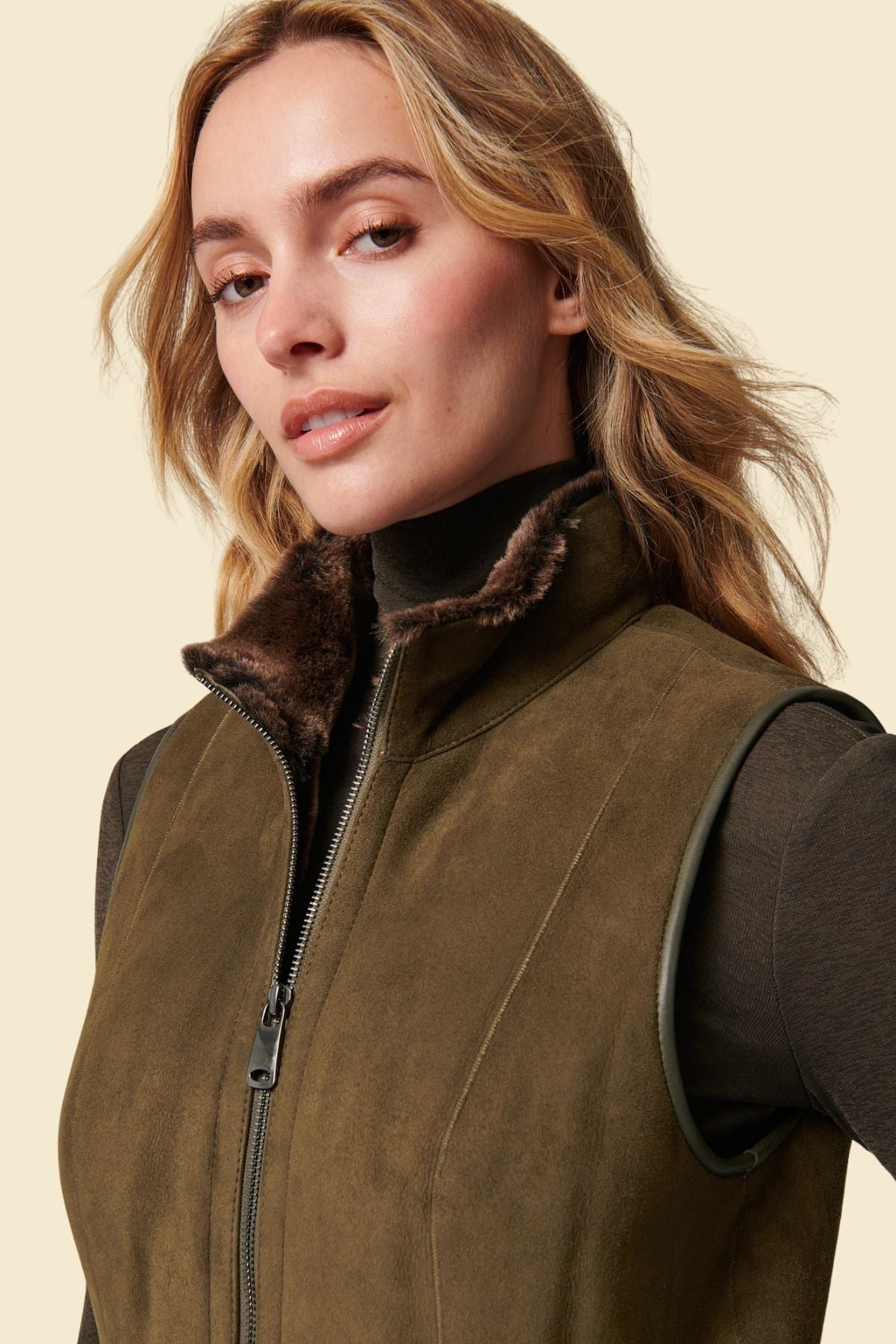 Neutral-toned women’s suede vest with soft faux fur interior.