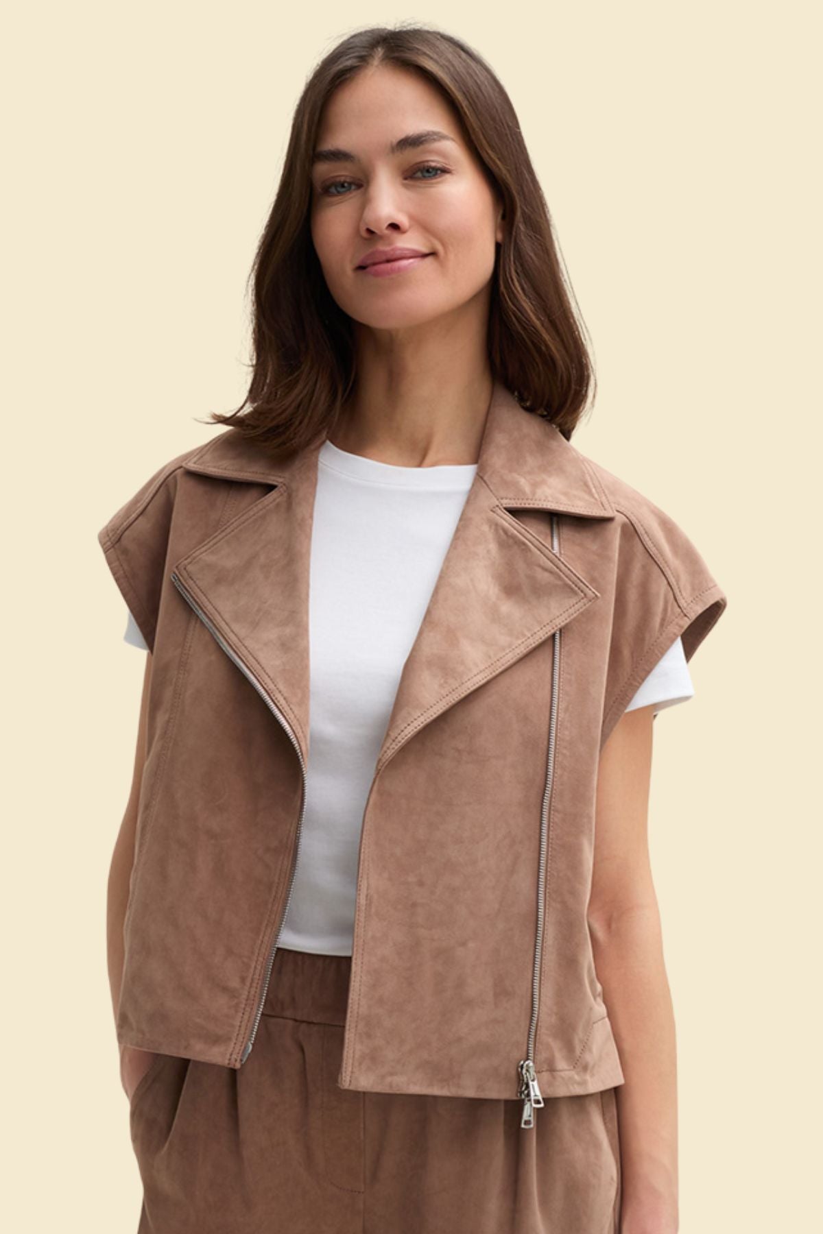 Soft brown suede motorcycle vest with polyester lining for women.