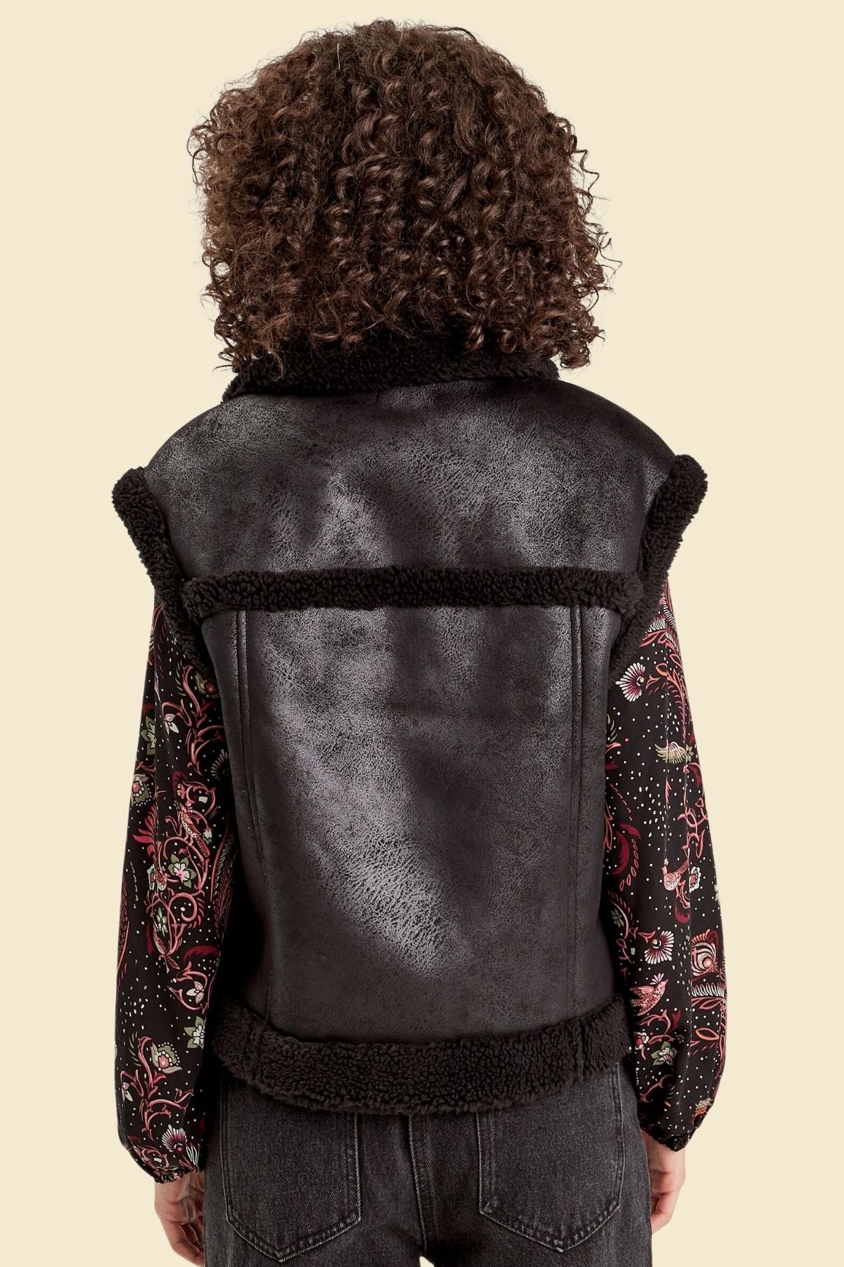Faux fur-lined sheepskin leather vest in black for women’s winter fashion.