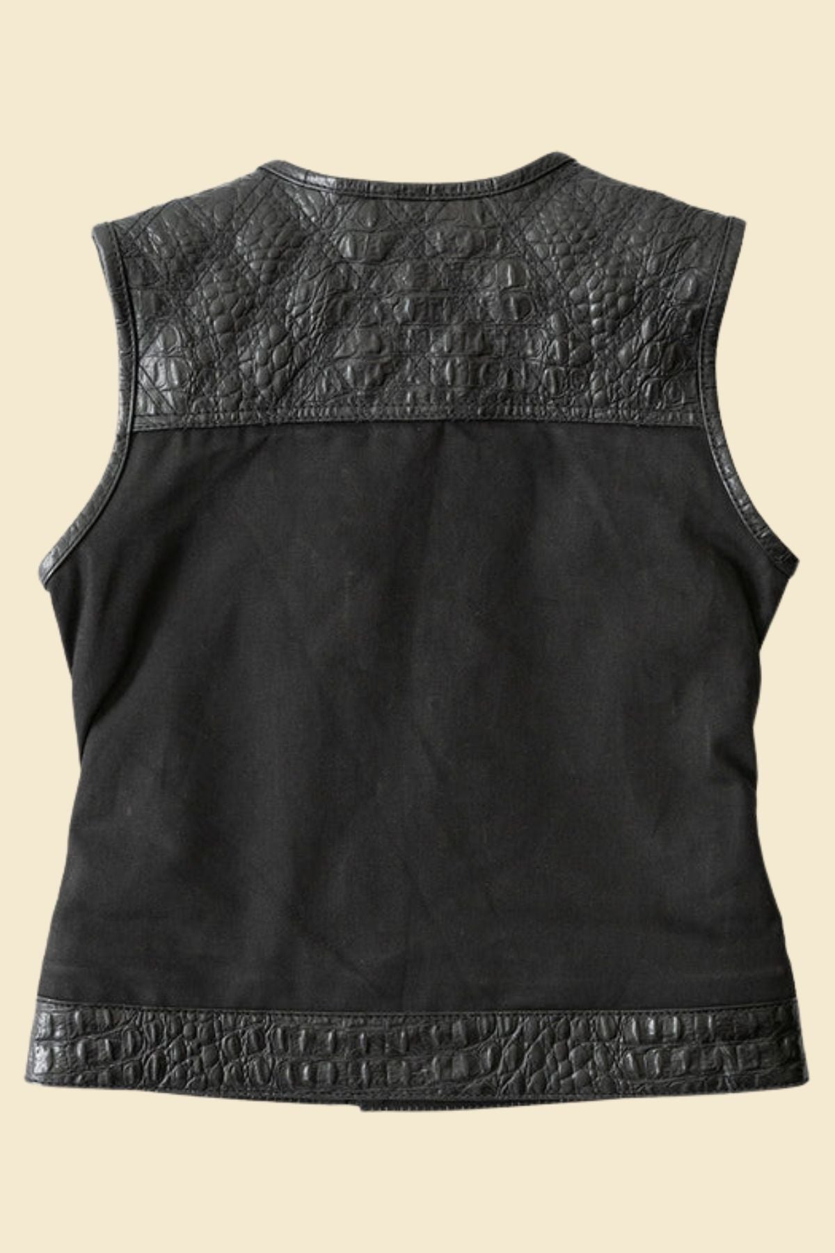 Close-up of embossed crocodile texture on women’s black leather vest