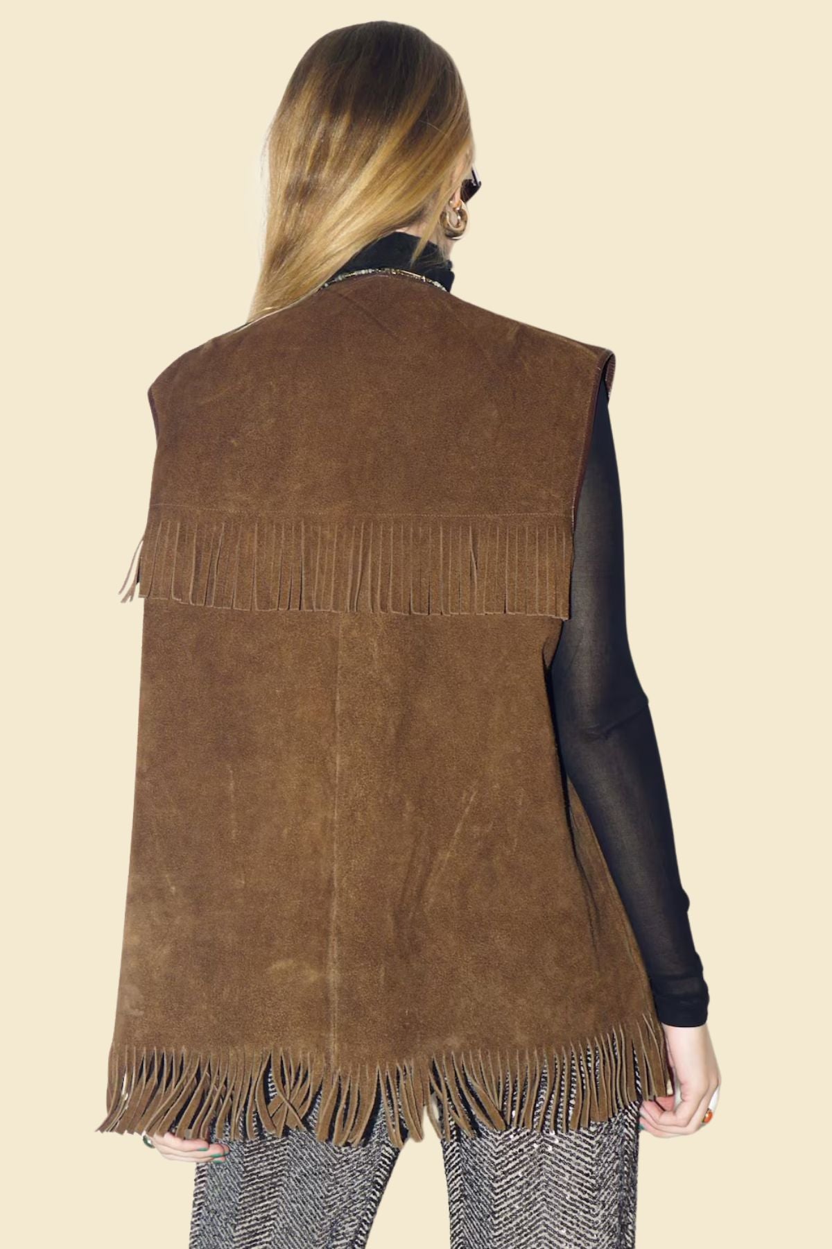 Detailed close-up of long suede fringe and Western stitching.