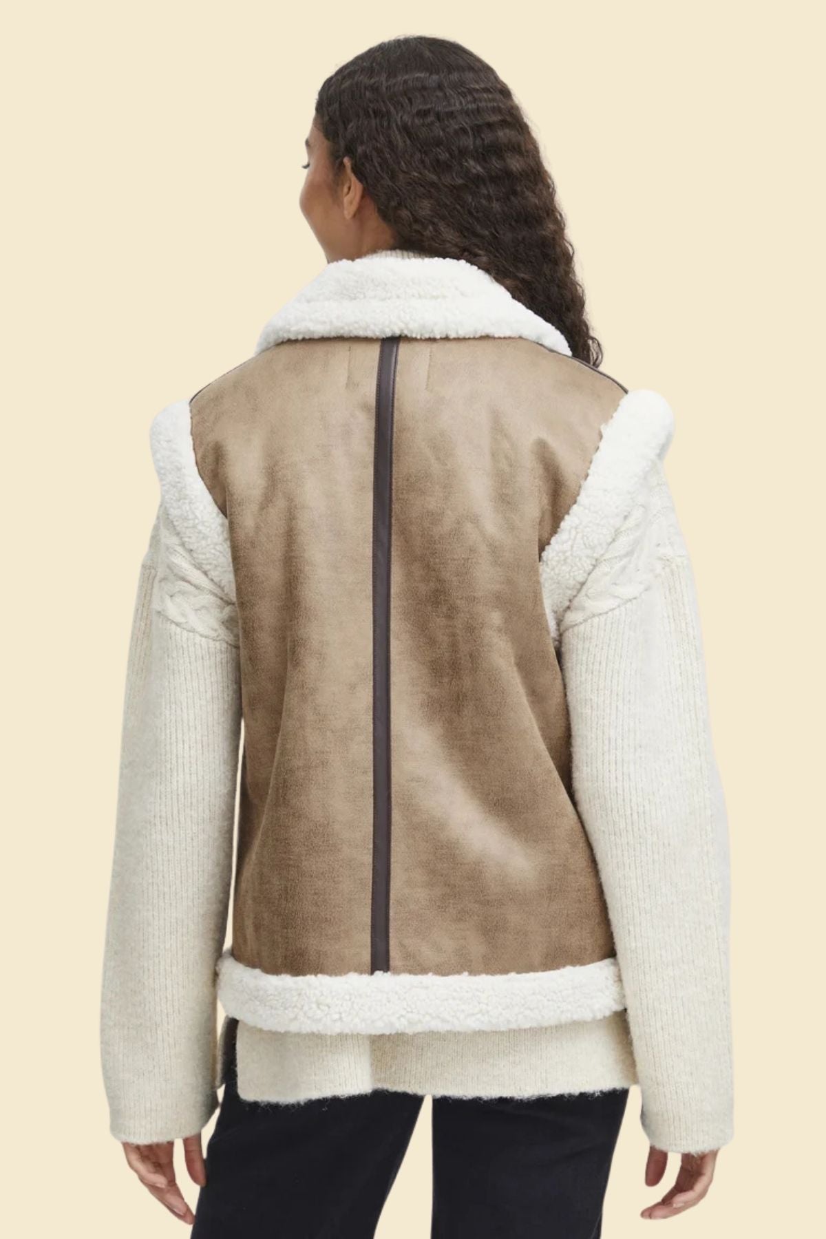 Stylish brown leather vest with sherpa lining, perfect for layering in colder seasons.