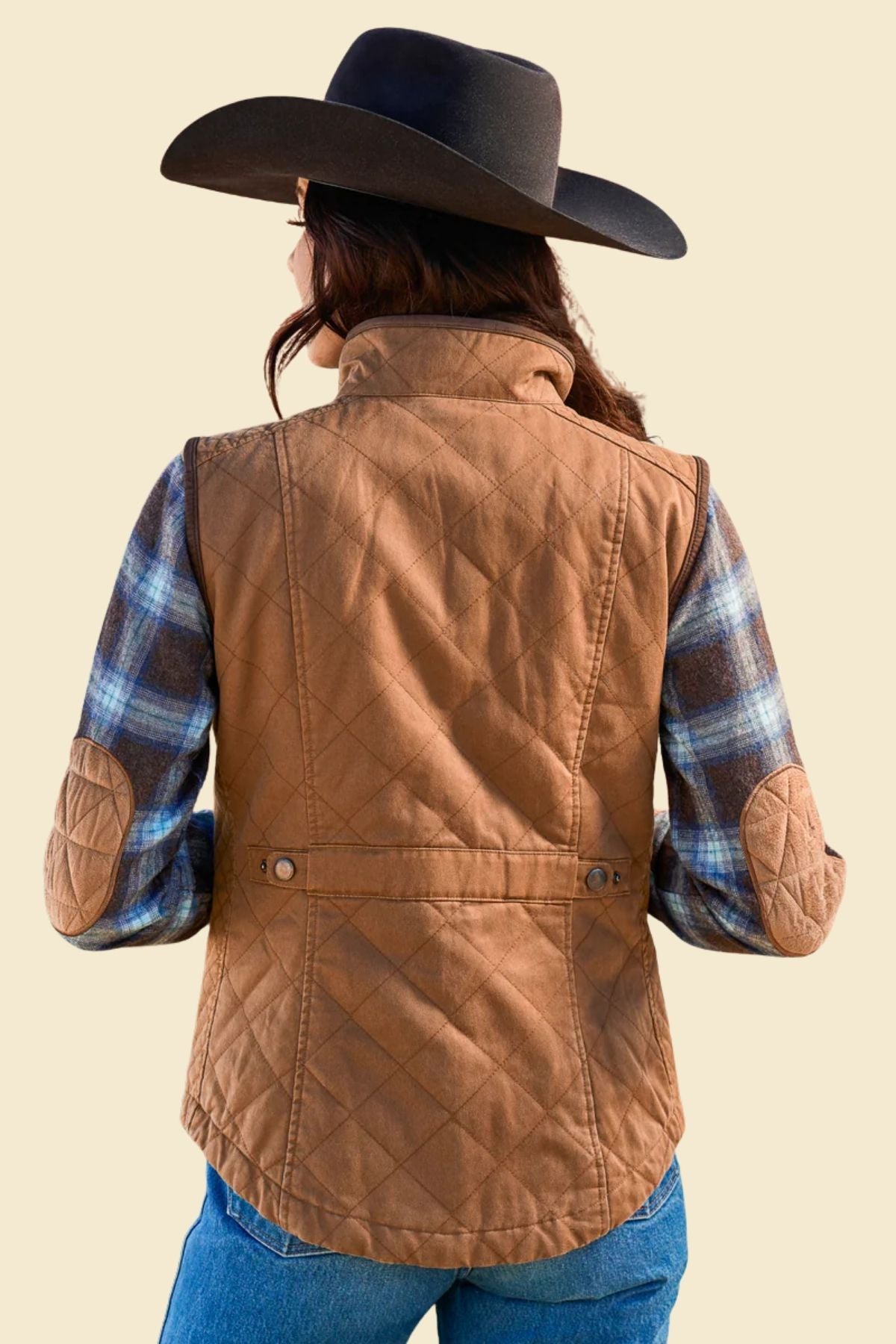 Close-up of quilted pattern on women’s brown leather vest