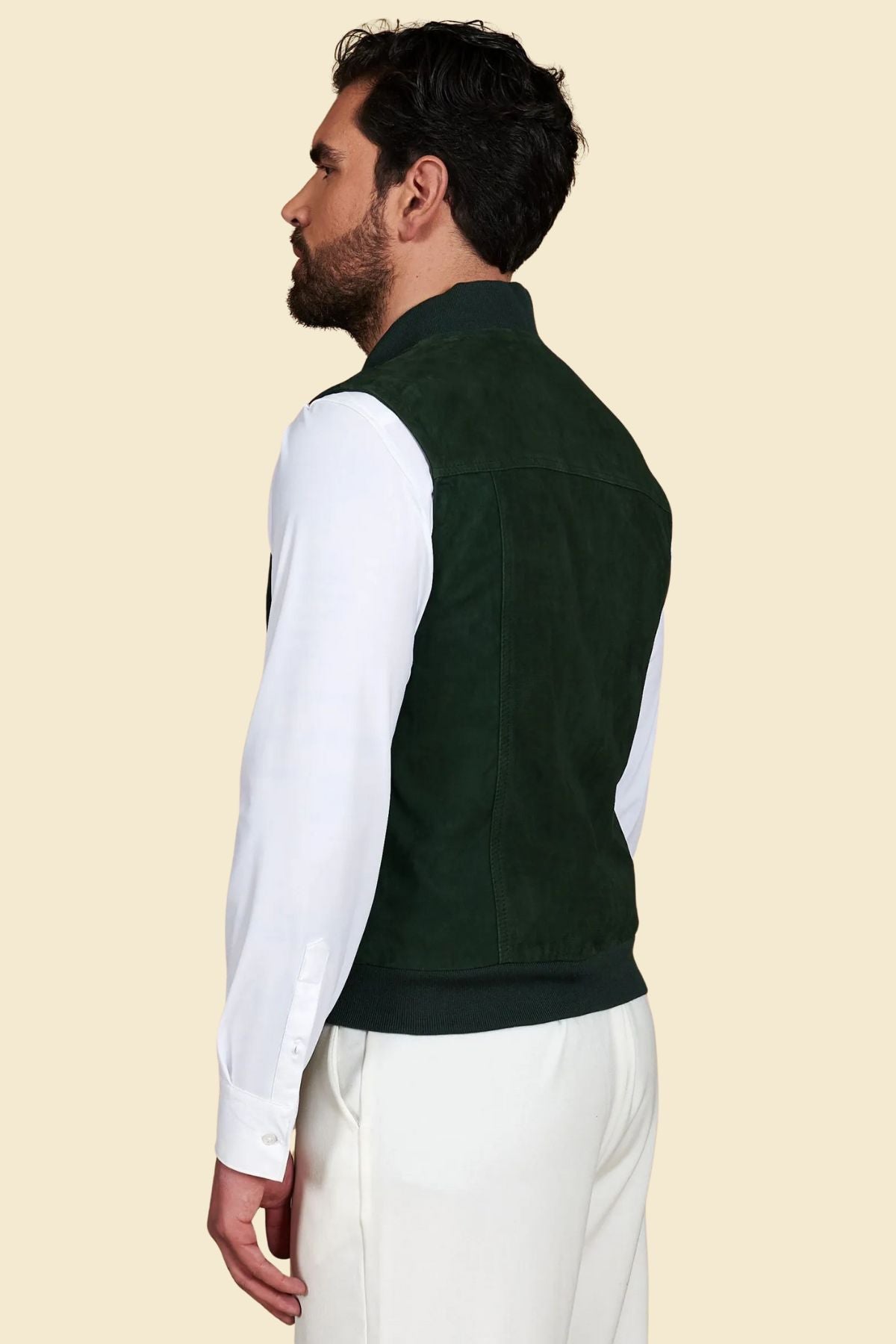 green suede vest showing clean seams and bomber-style silhouette.