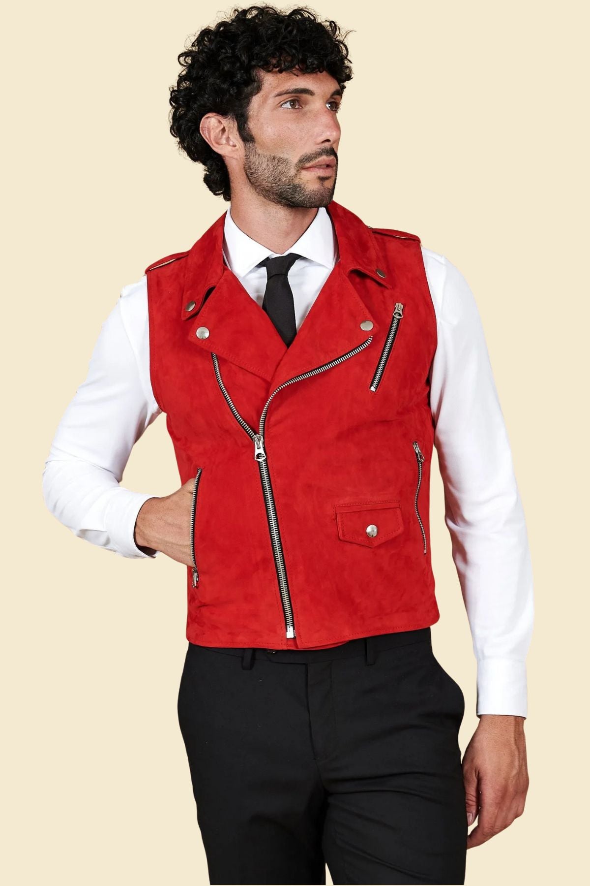 Man styling red suede biker vest with jeans and boots, showcasing urban motorcycle streetwear fashion.
