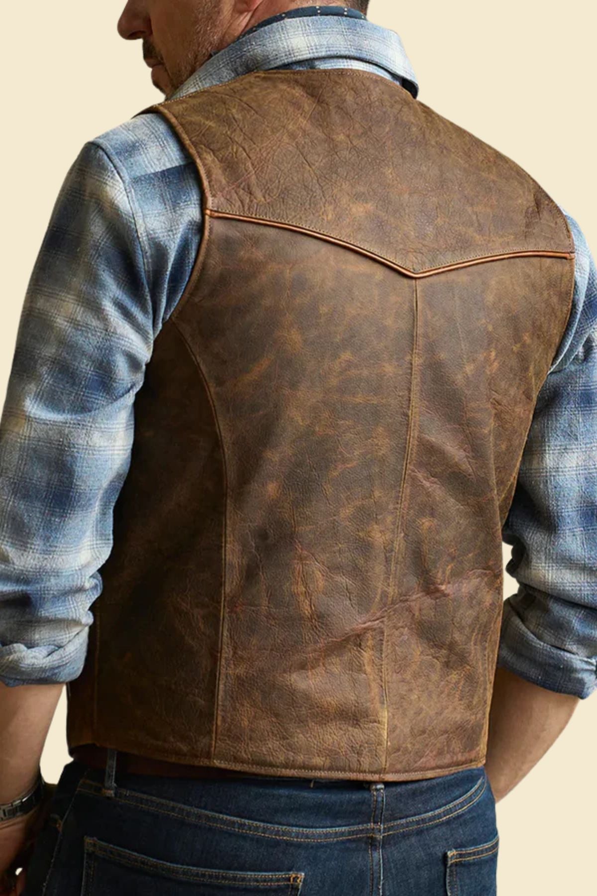 distressed brown cowhide Western vest with boots and jeans for a vintage cowboy outfit.