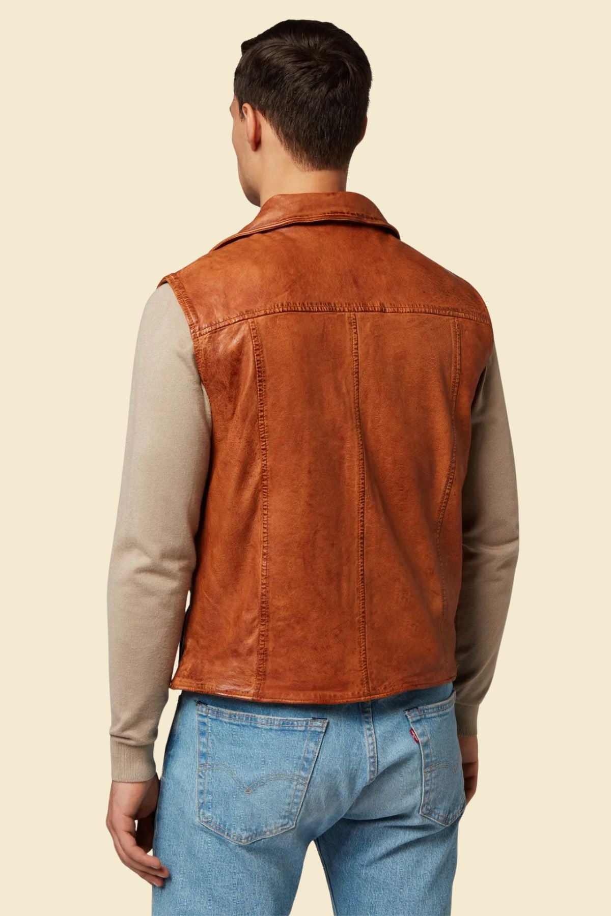 Brown leather motorcycle vest styled with rider gear and casual clothing