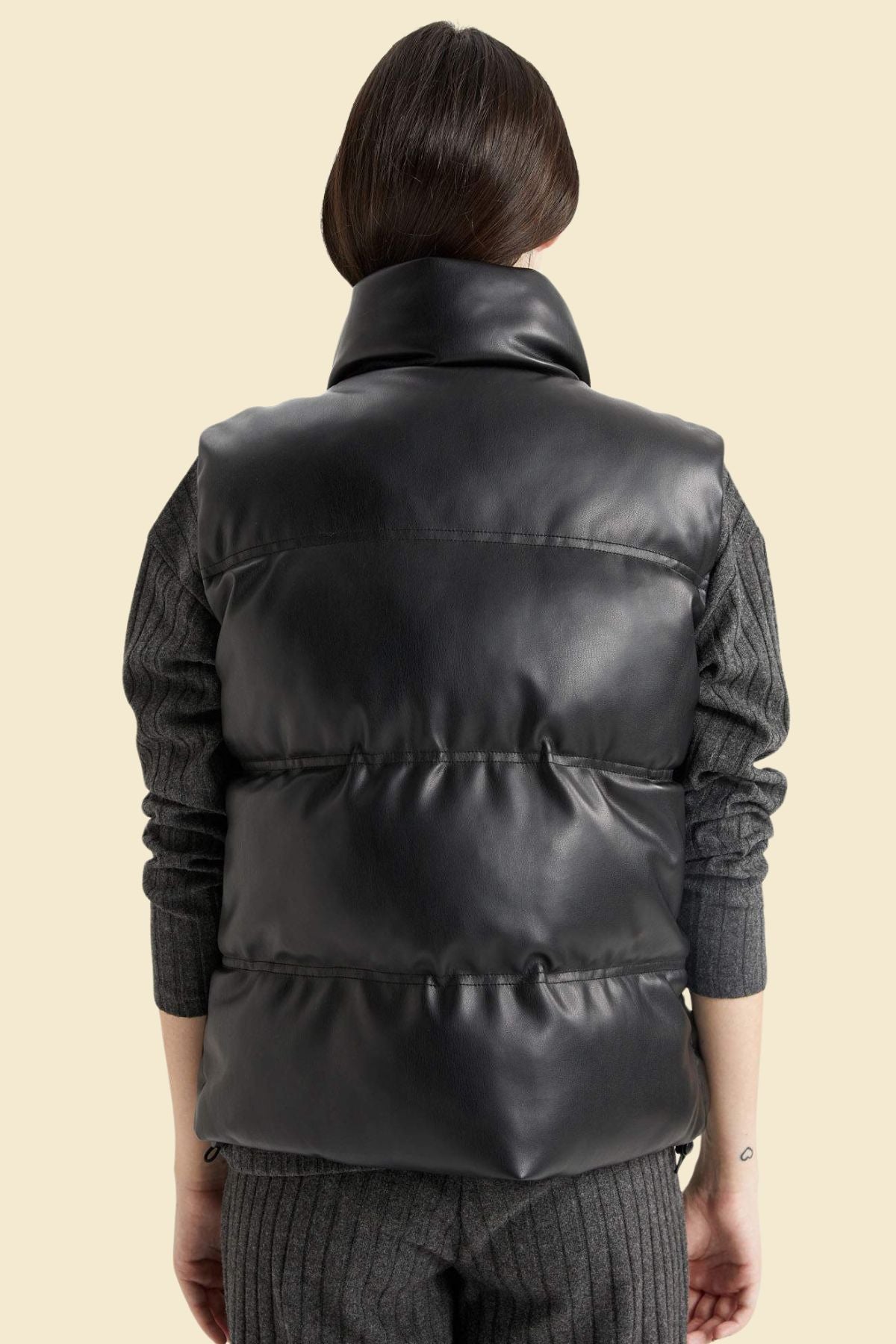 plus size black leather puffer vest with lightweight warmth.