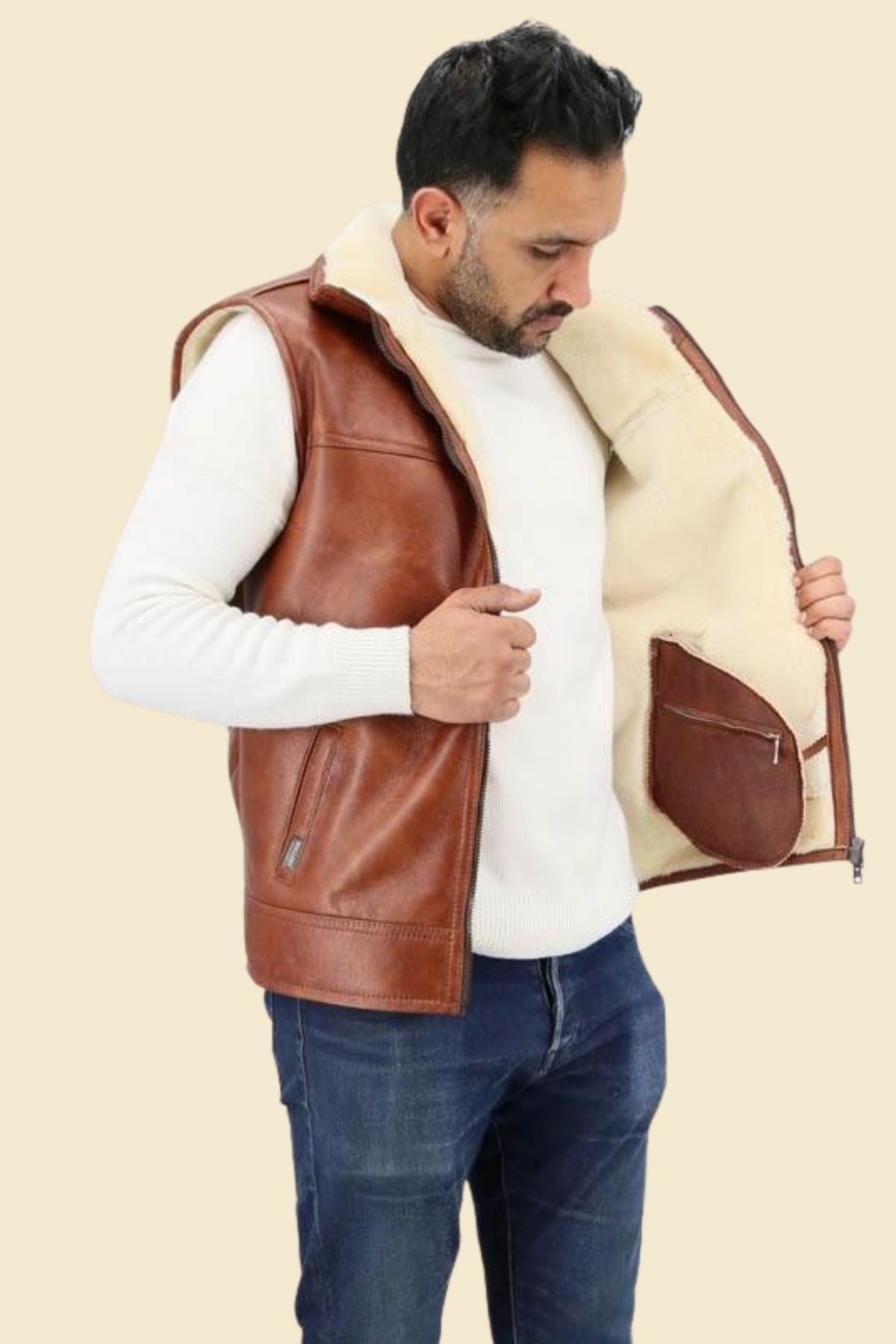 Men’s sheepskin aviator vest styled with boots and denim for a rugged streetwear look.