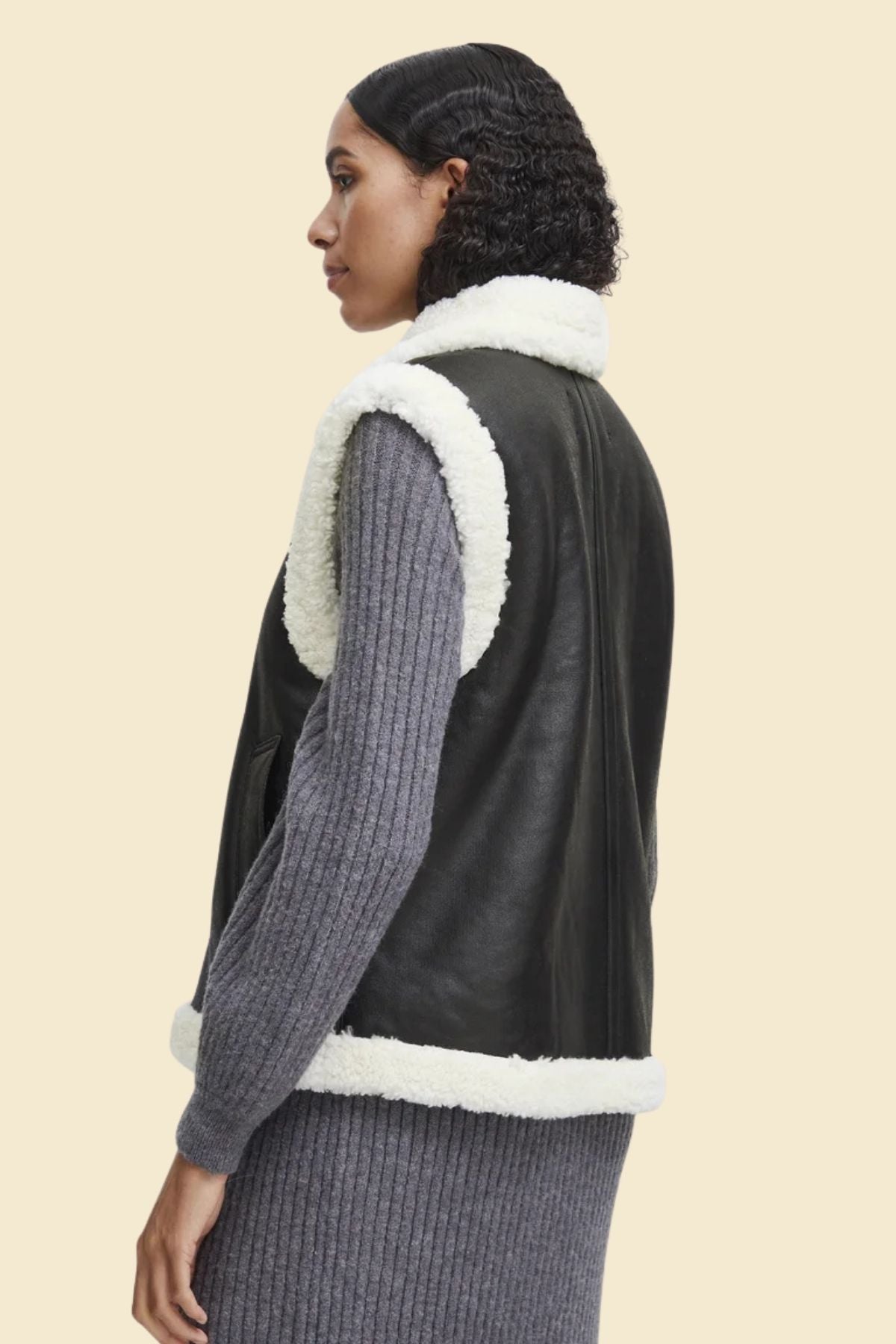 ladies’ leather and sherpa vest designed for warmth and elegance.