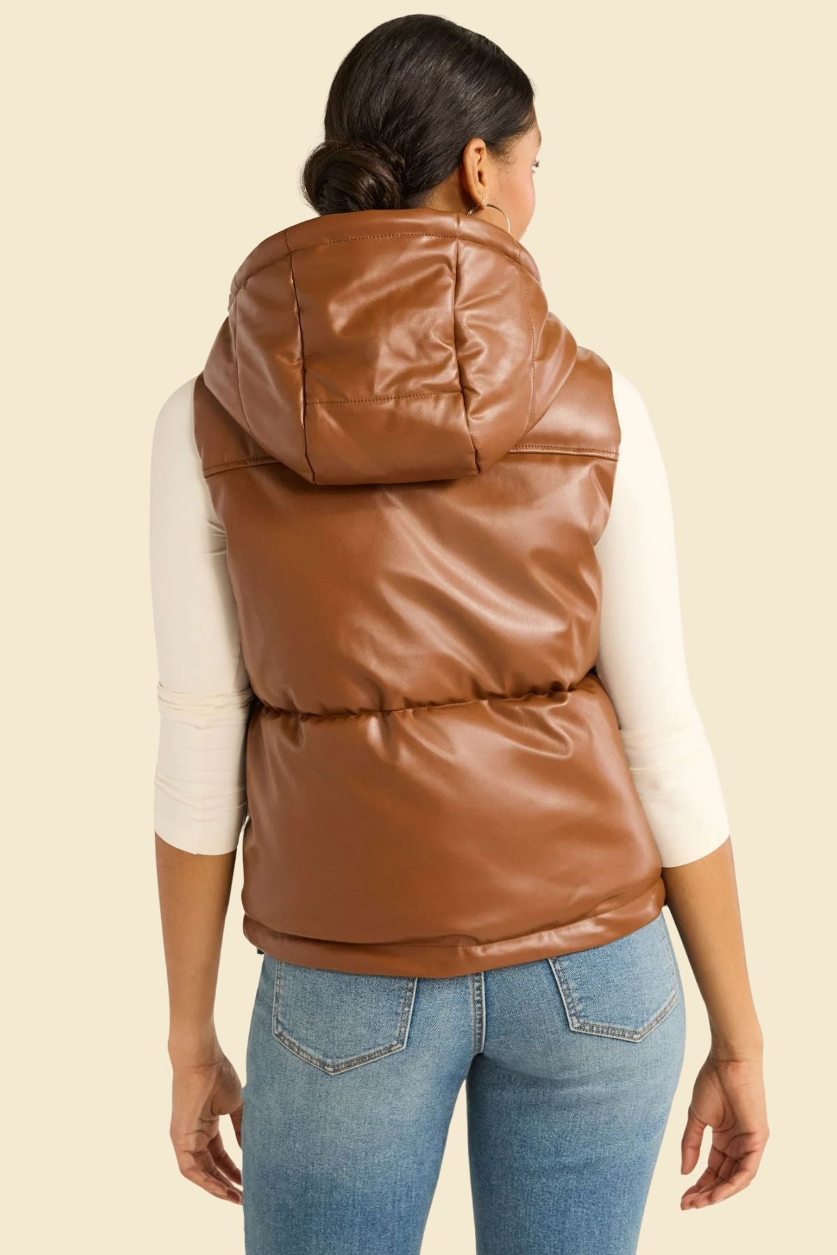 leather puffer vest in brown with insulated lining and hood.