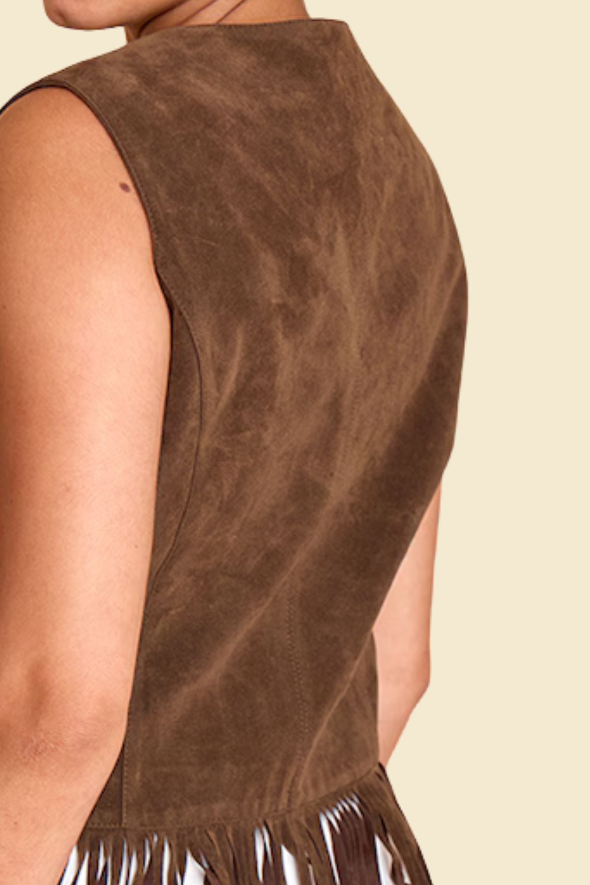 Western-inspired fringe vest in brown suede for casual wear.