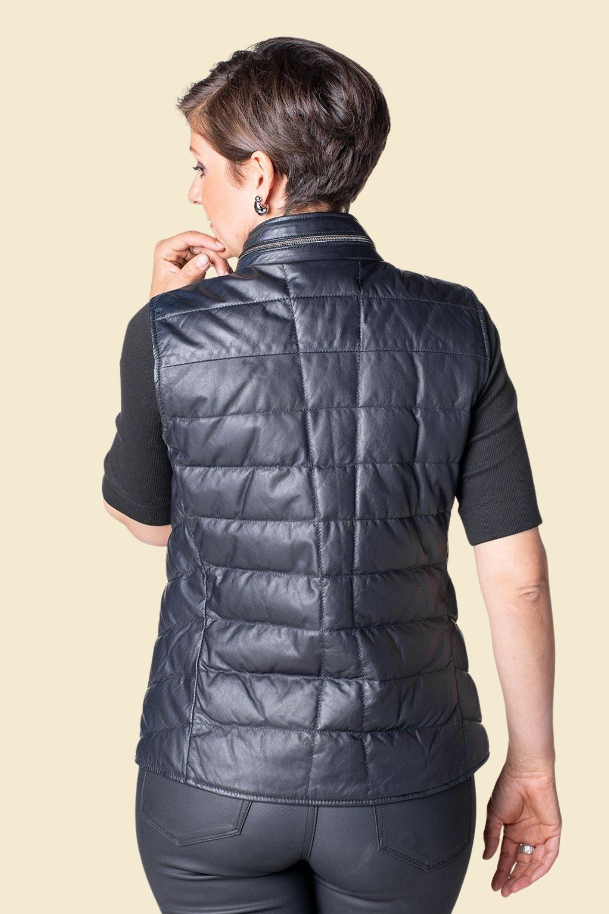 Stylish lightweight black leather puffer vest for women.