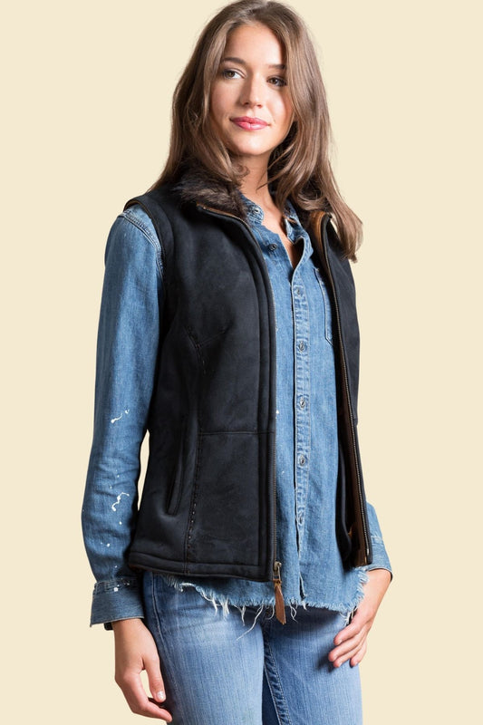 Women’s black sheepskin leather vest with faux fur lining and sleek fit.