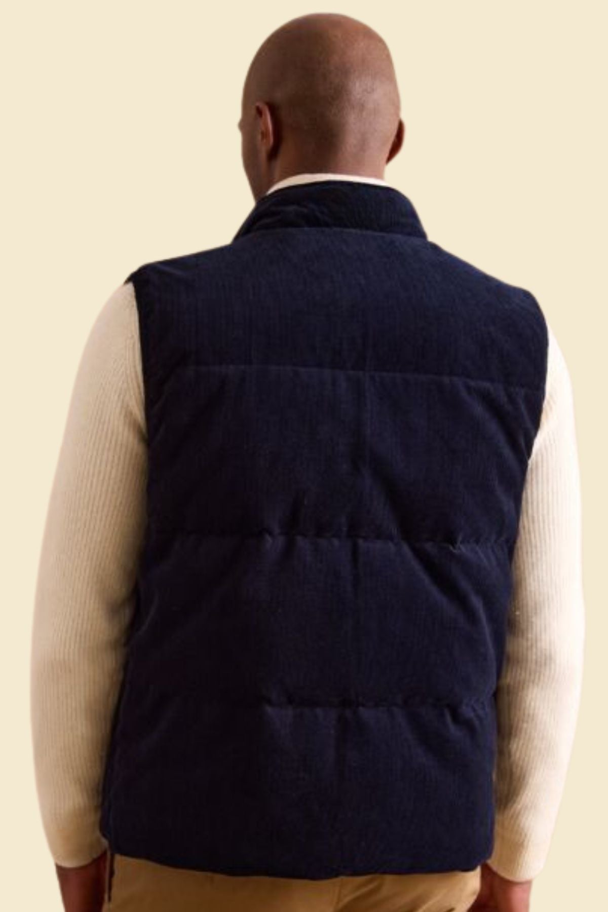 men’s puffer vest crafted from blue suede and polyester lining.