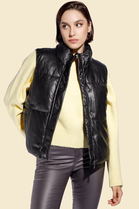 Women’s genuine sheepskin leather puffer vest in black with quilted design.