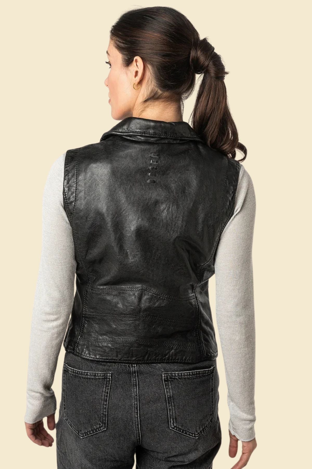 women’s motorcycle vest in black with durable leather exterior and smooth inner lining.