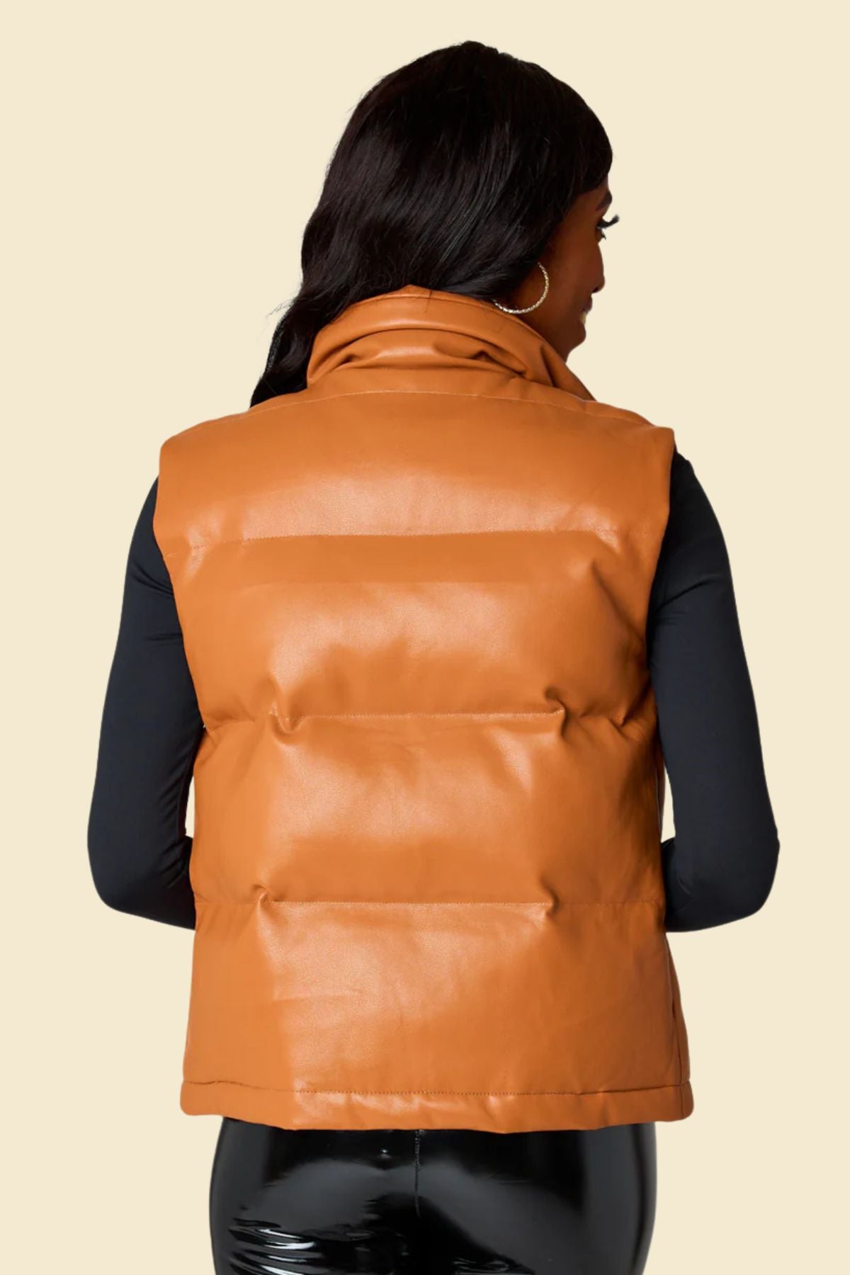  women’s leather puffer vest with quilted stitching.