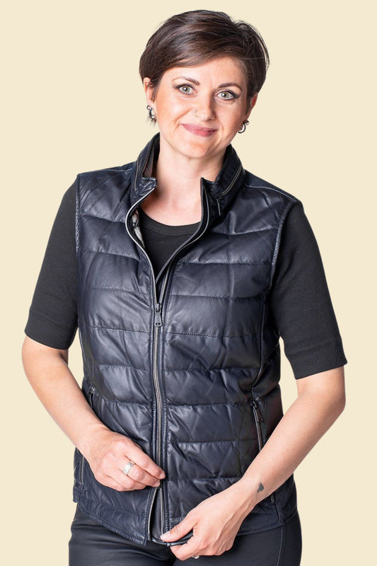 Women’s black lambskin leather puffer vest with sleek quilted design.